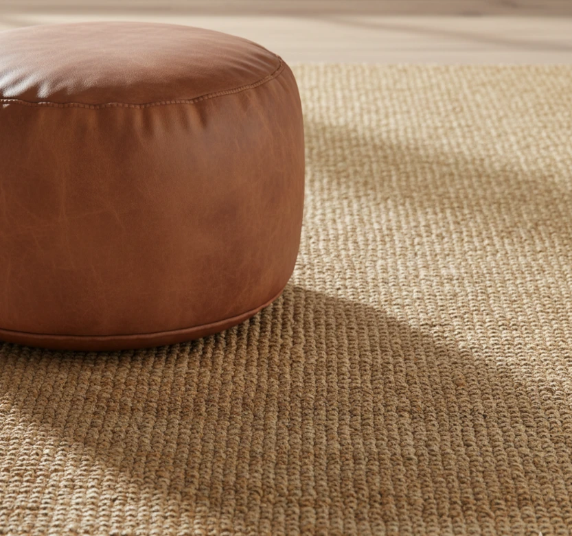 Flat-weave Jute carpet with leather pouf.