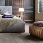 Neutral-carpet-in-modern-bedroom-with-dark-wood-paneling
